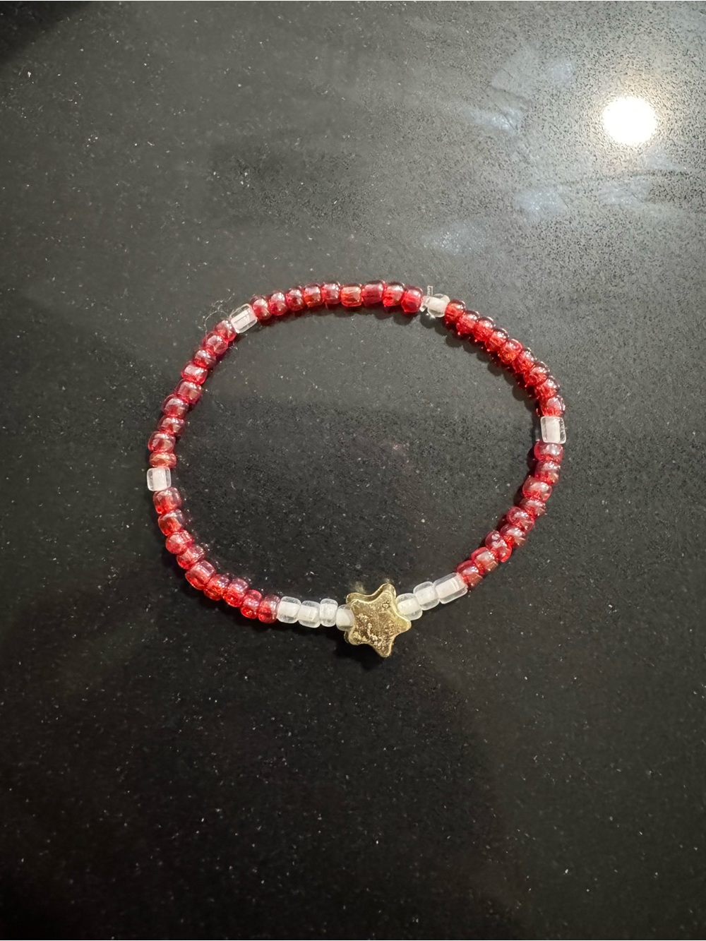 Red Beaded Bracelet with Gold Star Accent